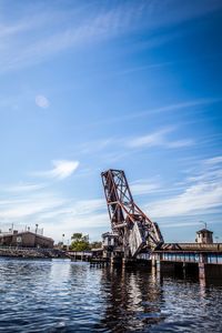 Calm sea against cloudy sky