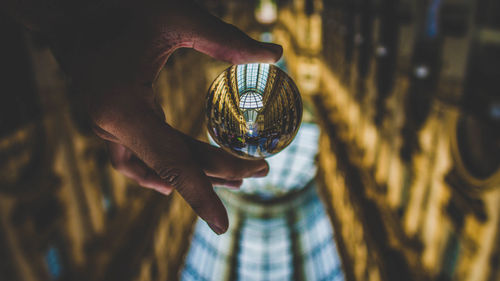 Close-up of hand holding glass of crystal ball