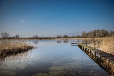 High angle view of pier over river against blue sky