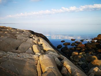 Rocks in sea against sky