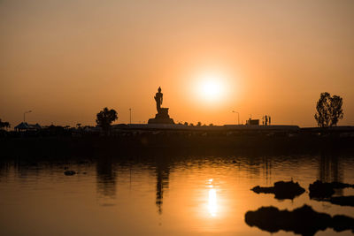 Silhouette of statue at sunset