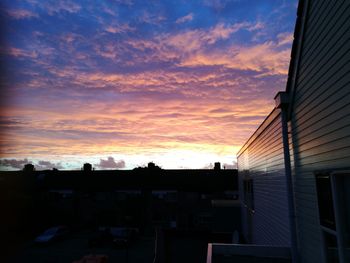 Houses against sky during sunset