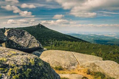 Scenic view of rocks on mountain against sky