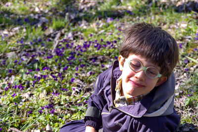 Portrait of boy on purple flowering plants