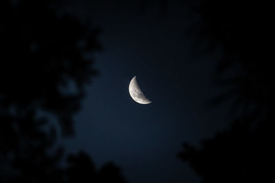 Low angle view of moon against sky at night