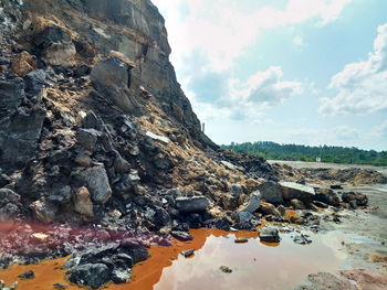 Rock formation on land against sky