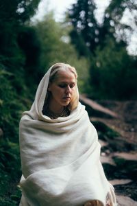 Portrait of young woman standing outdoors