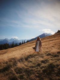 Woman on field against sky