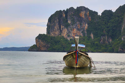 Boat moored on sea against sky