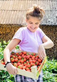 Girl holding fruits