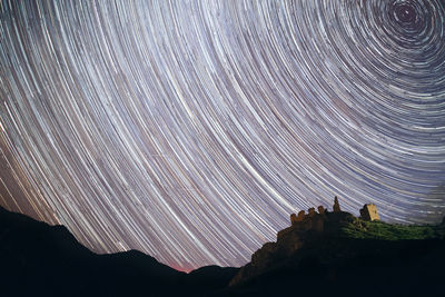 Scenic view of silhouette mountain against sky at night