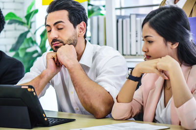 Young couple working on table