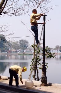 Full length of woman standing by railing