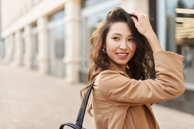 Portrait of young woman standing outdoors