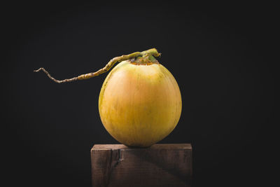 Close-up of apple on table against black background