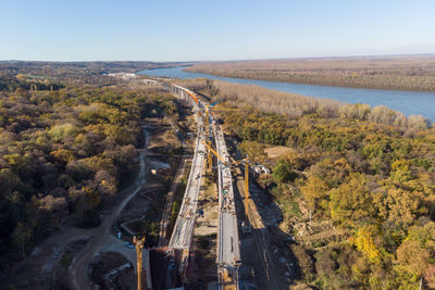 High angle view of road amidst trees against clear sky