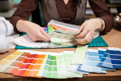 Midsection of business colleagues working on table