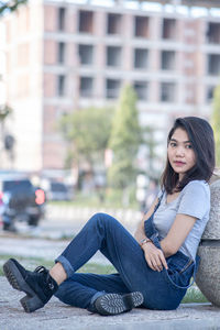 Young woman sitting in city