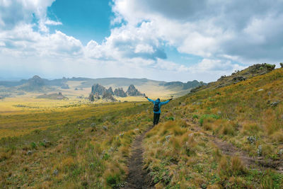 Rear view of a hiker against rock formations at the la satima dragons teeth in the aberdares, kenya