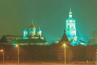 Illuminated building against sky at night