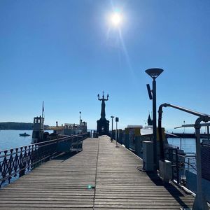 View of pier on sea against blue sky