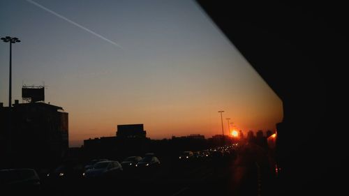 Traffic on road at sunset