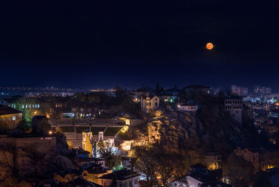 High angle view of illuminated buildings in city at night