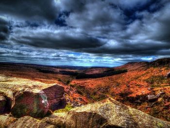 Scenic view of mountains against cloudy sky