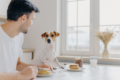 Close-up of man with dog at home