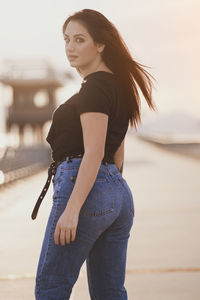 Full length of woman standing against sky