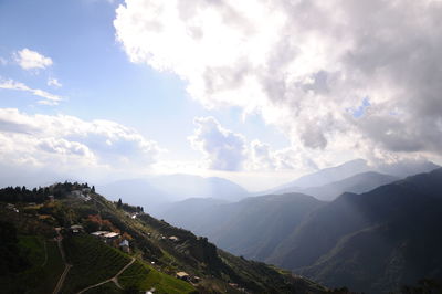 Scenic view of mountains against cloudy sky