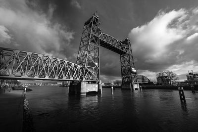 View of bridge over river against cloudy sky