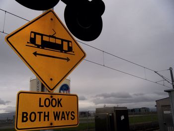 Low angle view of road sign against sky