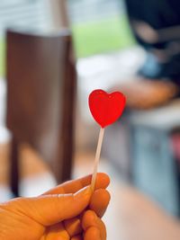 Close-up of hand holding red heart