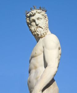 Low angle view of statue against blue sky