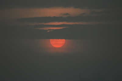 Scenic view of silhouette landscape against orange sky