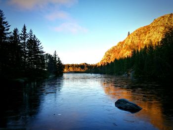 Scenic view of lake against sky at sunset