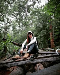 Portrait of man sitting on wood