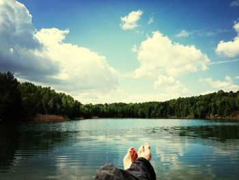 Scenic view of lake against cloudy sky