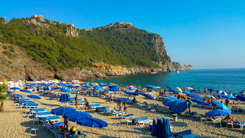 Panoramic view of beach against clear blue sky