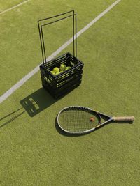 High angle view of tennis balls and racket on playing field