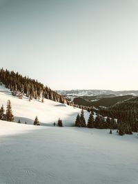 Scenic view of snowcapped mountains against clear sky