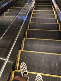 Low section of person on escalator