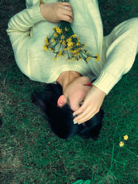 High angle view of woman relaxing on field