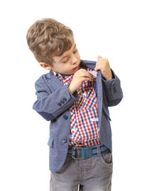 Full length of boy standing against white background