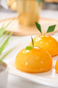 Close-up of orange slices in plate on table