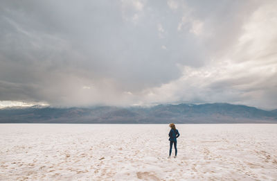 Full length of woman standing in desert