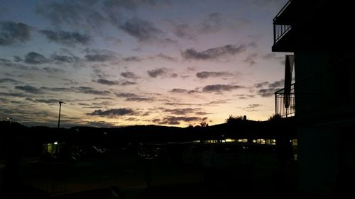 Low angle view of silhouette building against sky