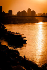 Scenic view of river against sky during sunset