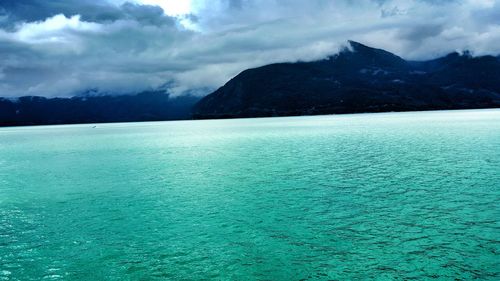 Scenic view of lake against cloudy sky